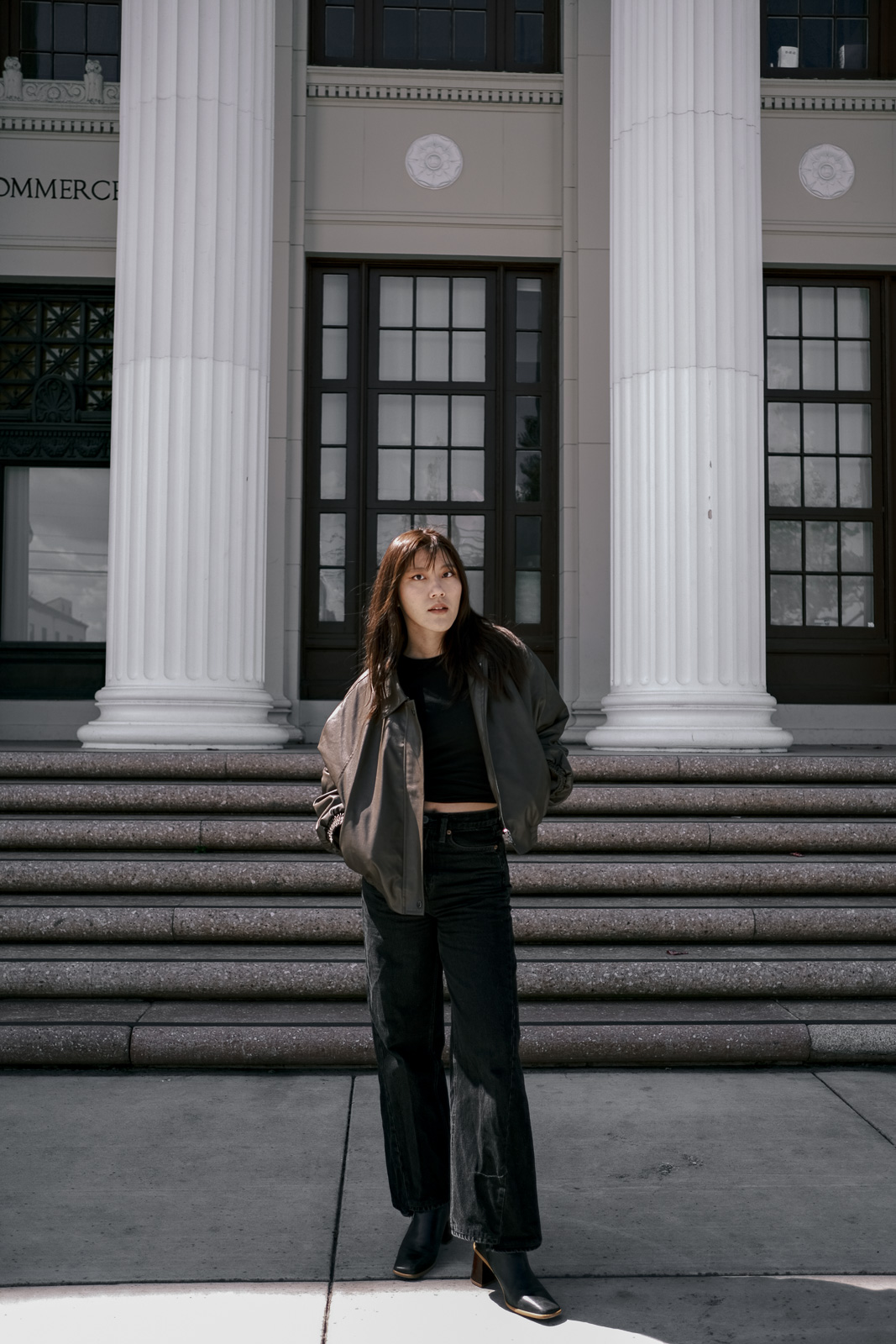 Brown leather jacket and black denim pants