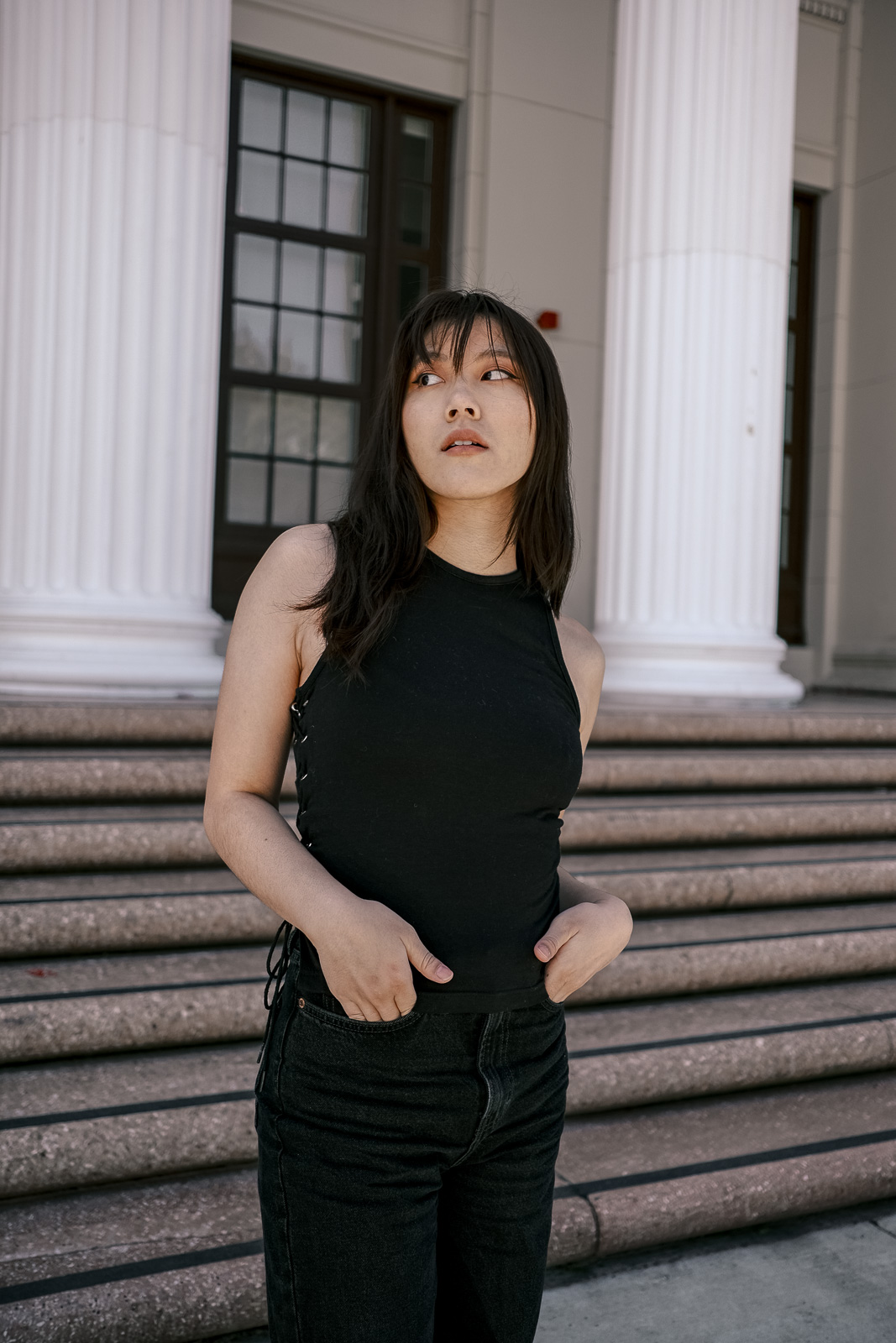 Black denim pants with back tank top half body shot